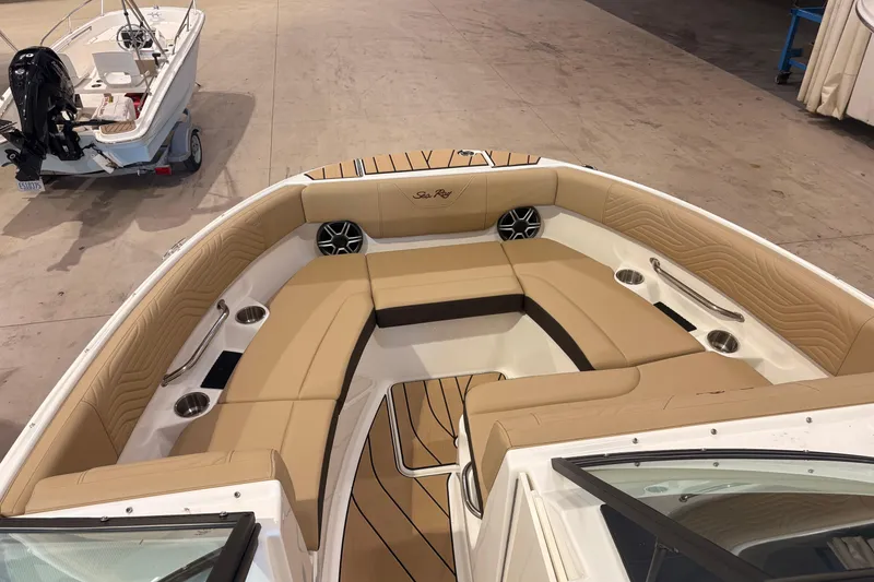 Slide: The Image of 2026 Sea Ray SDX 250 Surf boat interior with tan seating and cup holders. - 15
