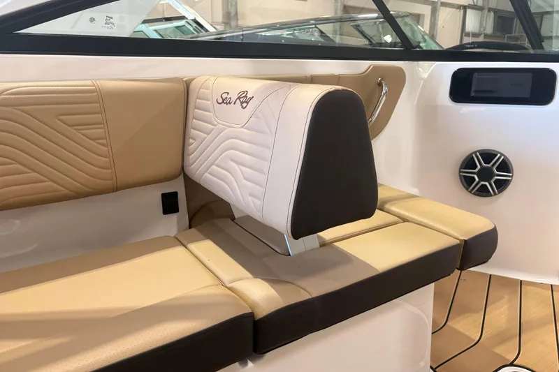 Slide: The Image of 2026 Sea Ray SDX 250 Surf boat interior with tan leather seating and speaker. - 16