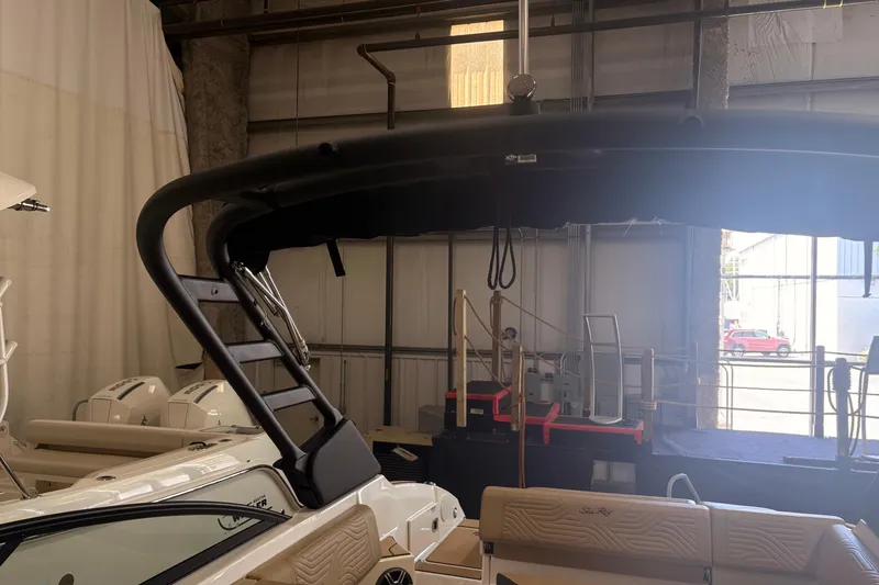 Slide: The Image of 2026 Sea Ray SDX 250 Surf boat interior in a warehouse setting. - 19