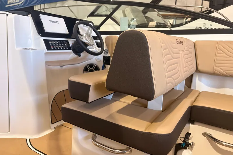 Slide: The Image of Interior of 2026 Sea Ray SDX 250 Surf boat with beige seating and modern dashboard. - 23
