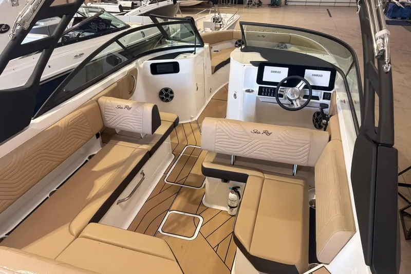 Slide: The Image of 2026 Sea Ray SDX 250 Surf boat interior with beige seating and modern dashboard. - 5