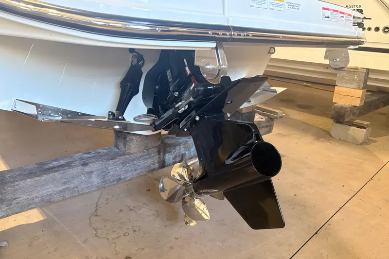 Slide: The Image of 2026 Sea Ray SDX 250 Surf boat propeller and stern drive detail in a showroom. - 7