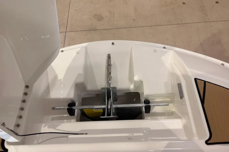 Slide: The Image of Anchor compartment of 2026 Sea Ray SDX 250 Surf boat, showcasing storage design. - 8