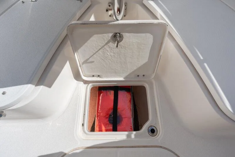 Slide: The Image of 2017 Robalo R222 Center Console storage compartment with safety equipment. - 14