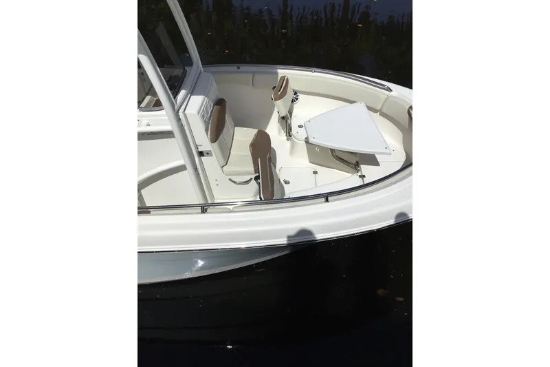 Slide: The Image of 2017 Robalo R222 Center Console boat interior with seating and table. - 3