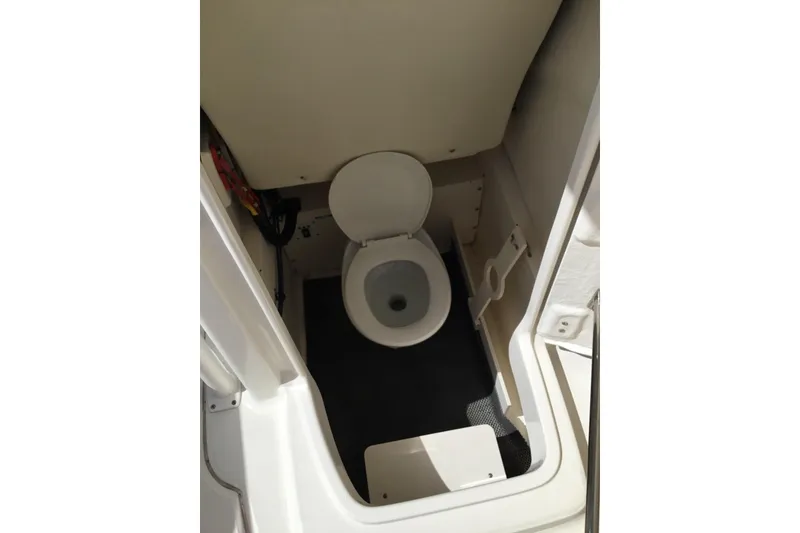 Slide: The Image of 2017 Robalo R222 Center Console boat interior with toilet compartment. - 5
