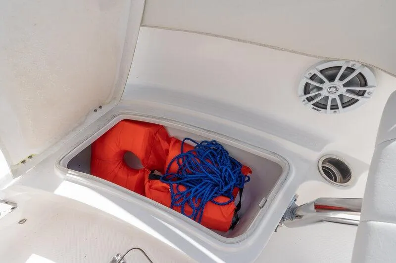 Slide: The Image of Storage compartment on 2017 Robalo R222 Center Console with life jackets and blue rope. - 25