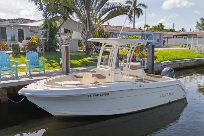 Slide: The Image of 2017 Robalo R222 Center Console boat docked by a waterfront home. - 32