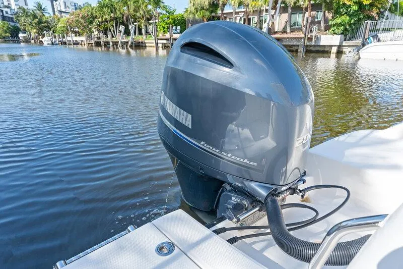 Slide: The Image of 2017 Robalo R222 Center Console with Yamaha outboard motor on a calm waterway. - 16
