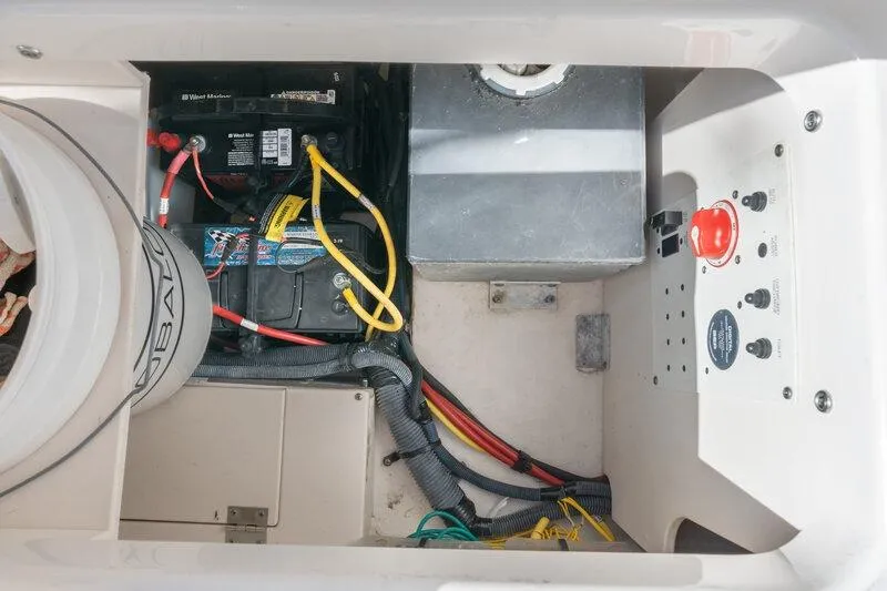 Slide: The Image of 2017 Robalo R222 Center Console boat battery compartment with wiring and control panel. - 21