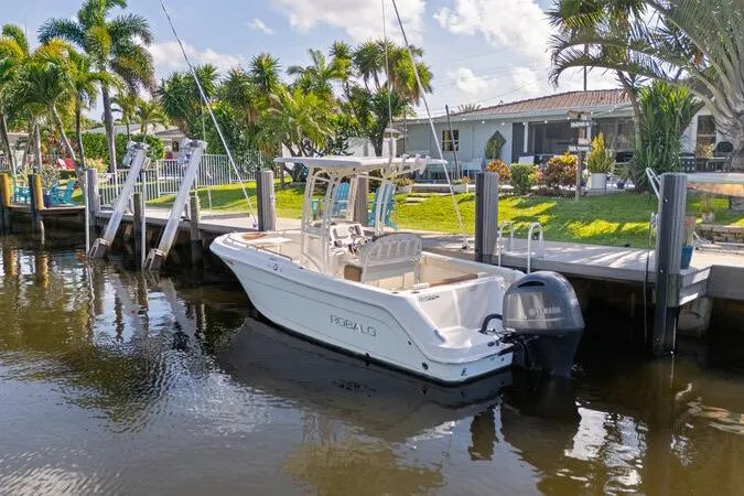 Slide: The Image of 2017 Robalo R222 Center Console boat docked by a waterfront home. - 20