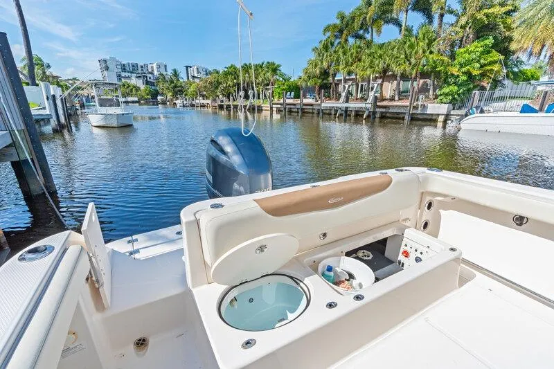 Slide: The Image of 2017 Robalo R222 Center Console boat docked in a scenic waterfront setting. - 28