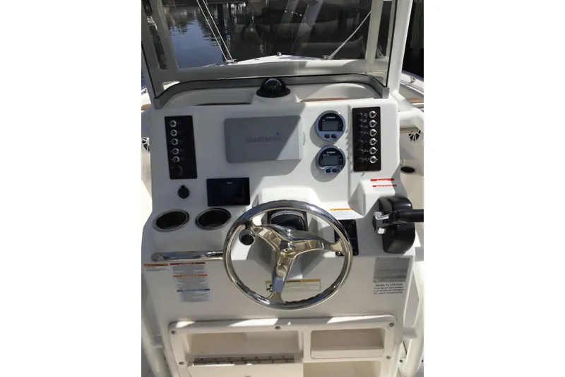 Slide: The Image of 2017 Robalo R222 Center Console boat dashboard with Garmin navigation system and steering wheel. - 6