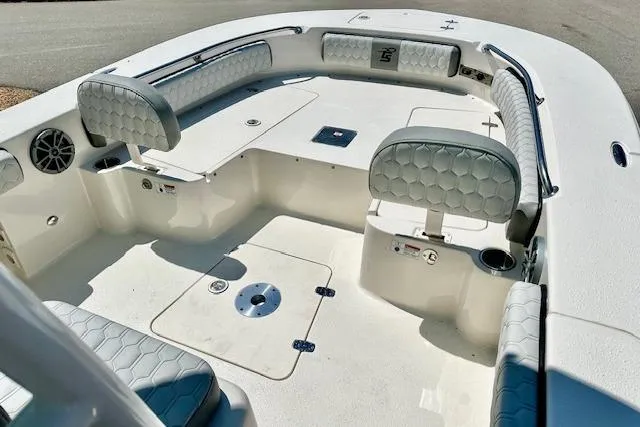 Slide: The Image of 2026 Carolina Skiff 24 Ultra Elite boat interior with cushioned seating and storage compartments. - 10