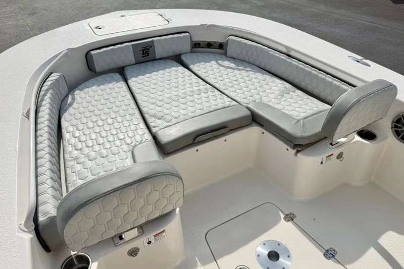 Slide: The Image of Luxurious seating on 2026 Carolina Skiff 24 Ultra Elite boat, featuring hexagonal-patterned upholstery. - 11
