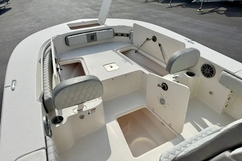 Slide: The Image of 2026 Carolina Skiff 24 Ultra Elite boat interior with seating and storage compartments. - 13