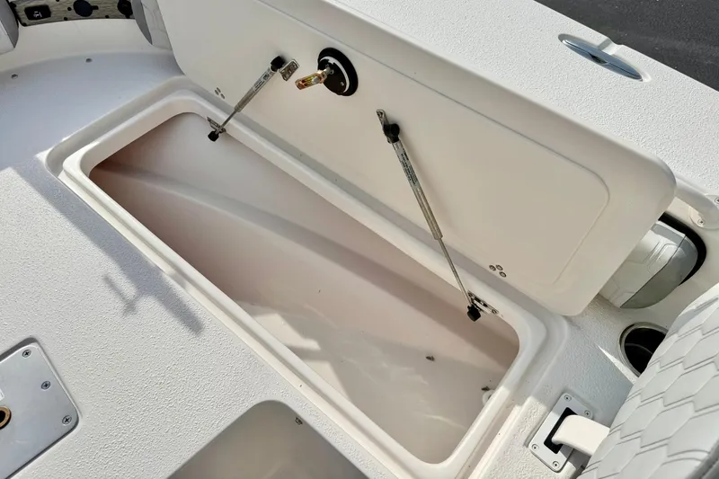 Slide: The Image of Open storage compartment on a 2026 Carolina Skiff 24 Ultra Elite boat. - 17