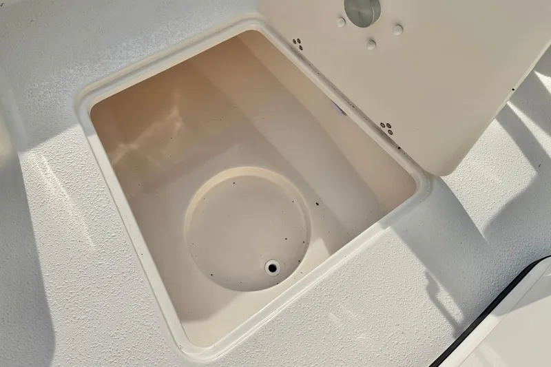 Slide: The Image of Open storage compartment on 2026 Carolina Skiff 24 Ultra Elite boat. - 18