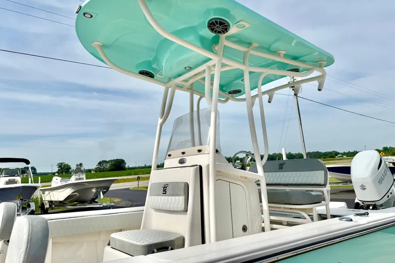 Slide: The Image of 2026 Carolina Skiff 24 Ultra Elite boat with T-top and Suzuki outboard motor. - 19