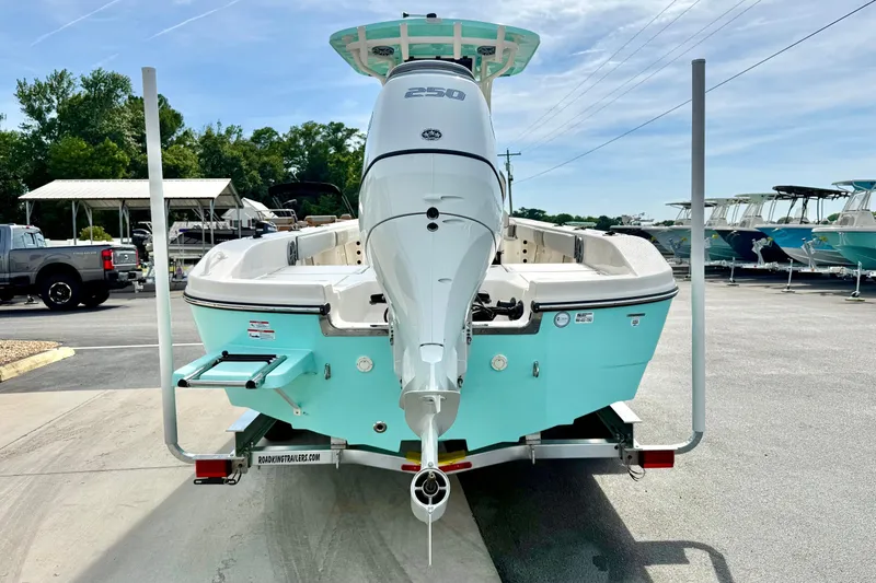 Slide: The Image of 2026 Carolina Skiff 24 Ultra Elite boat on trailer, featuring powerful outboard motor. - 2