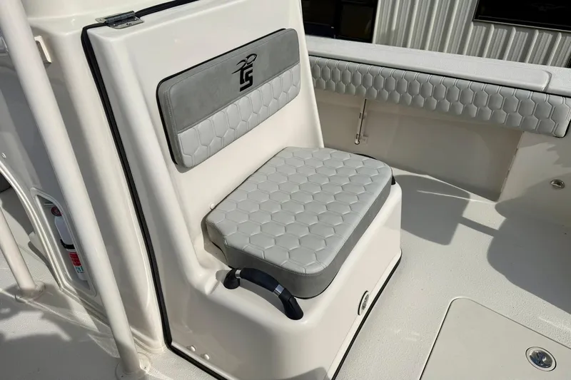 Slide: The Image of 2026 Carolina Skiff 24 Ultra Elite boat seat with gray cushioned upholstery. - 20