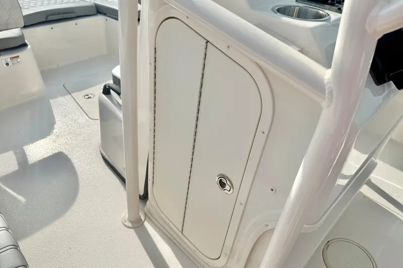 Slide: The Image of 2026 Carolina Skiff 24 Ultra Elite boat interior with storage compartment and seating. - 22