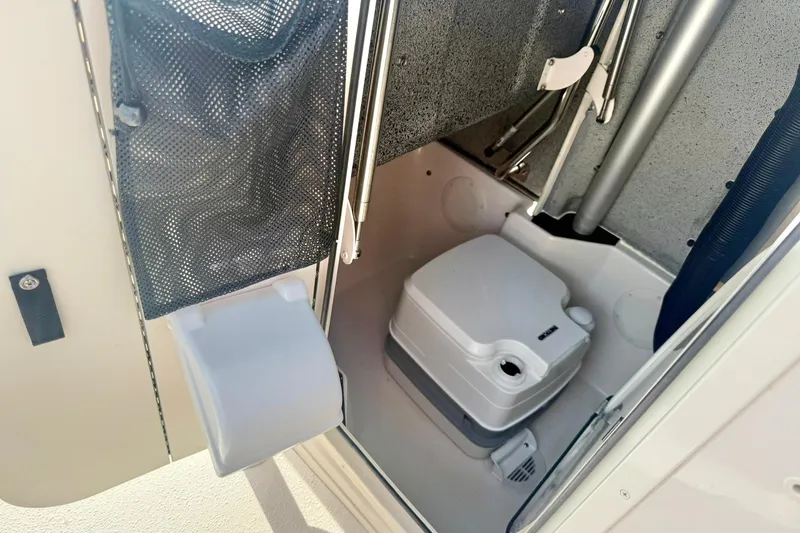 Slide: The Image of Interior of 2026 Carolina Skiff 24 Ultra Elite boat with compact marine toilet. - 23