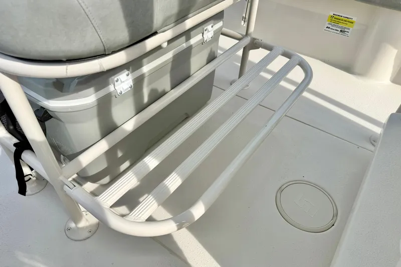 Slide: The Image of 2026 Carolina Skiff 24 Ultra Elite boat interior with cooler and seating area. - 26