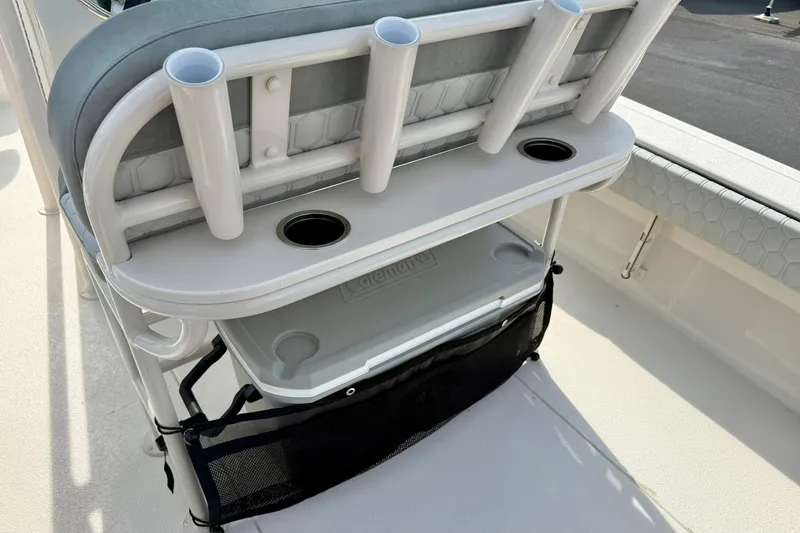 Slide: The Image of 2026 Carolina Skiff 24 Ultra Elite boat seating with rod holders and storage compartment. - 27