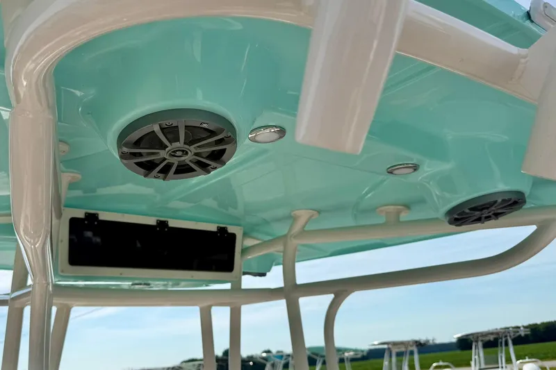 Slide: The Image of 2026 Carolina Skiff 24 Ultra Elite boat interior with speakers and teal ceiling. - 29