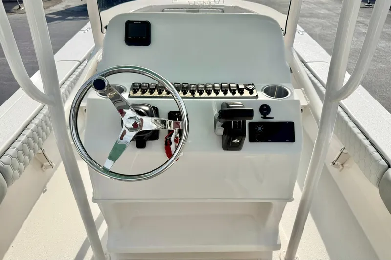 Slide: The Image of 2026 Carolina Skiff 24 Ultra Elite boat console with steering wheel and controls. - 3