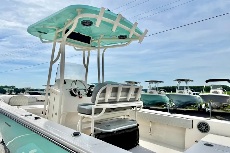Slide: The Image of 2026 Carolina Skiff 24 Ultra Elite boat with T-top and seating, displayed outdoors. - 32