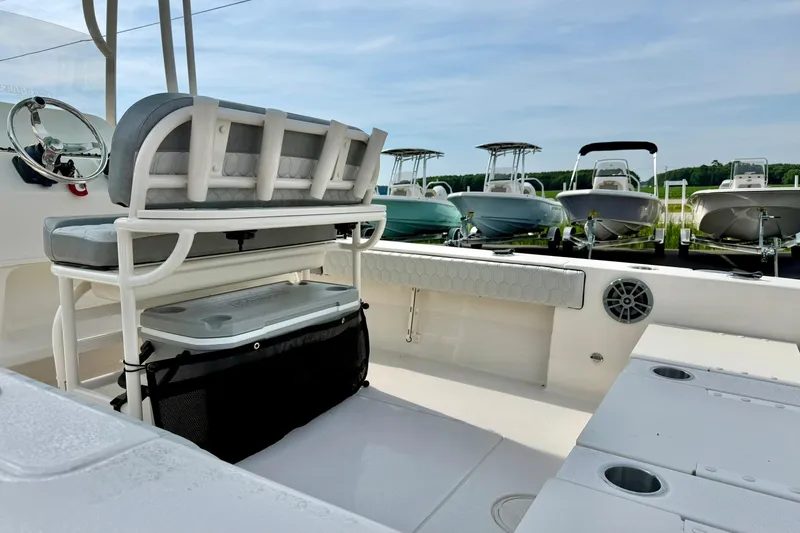 Slide: The Image of 2026 Carolina Skiff 24 Ultra Elite boat interior with seating and storage, surrounded by other boats. - 33