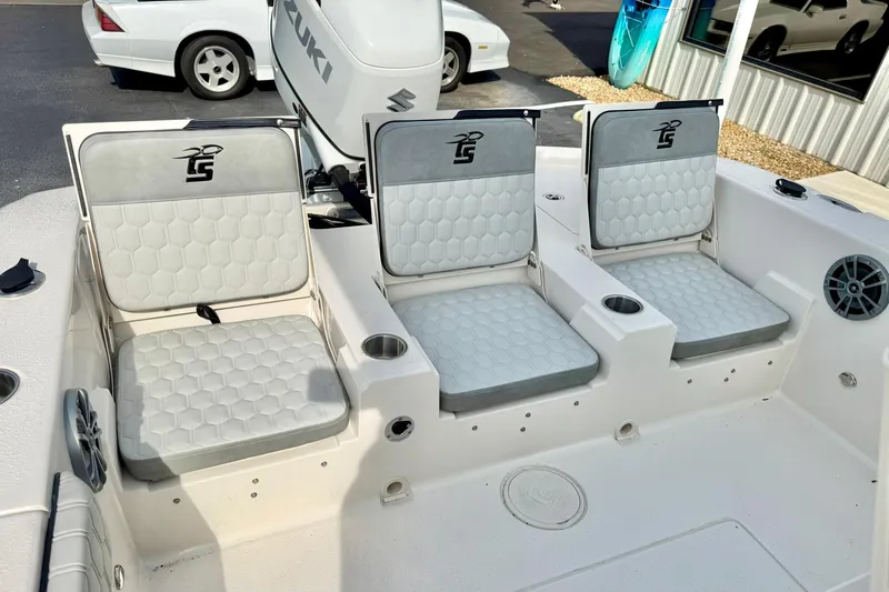 Slide: The Image of 2026 Carolina Skiff 24 Ultra Elite boat seating with Suzuki engine, featuring comfortable cushions. - 35