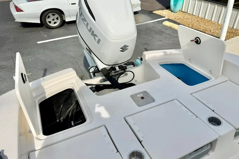 Slide: The Image of 2026 Carolina Skiff 24 Ultra Elite boat with Suzuki outboard motor and storage compartments. - 37