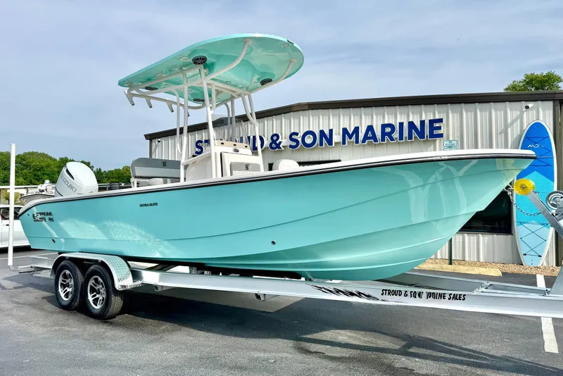 Slide: The Image of 2026 Carolina Skiff 24 Ultra Elite boat on trailer at marine dealership. - 4