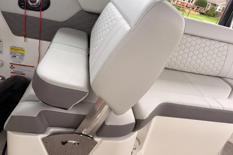 Slide: The Image of 2021 Sea Ray SDX 250 boat interior with white and gray seating. - 11