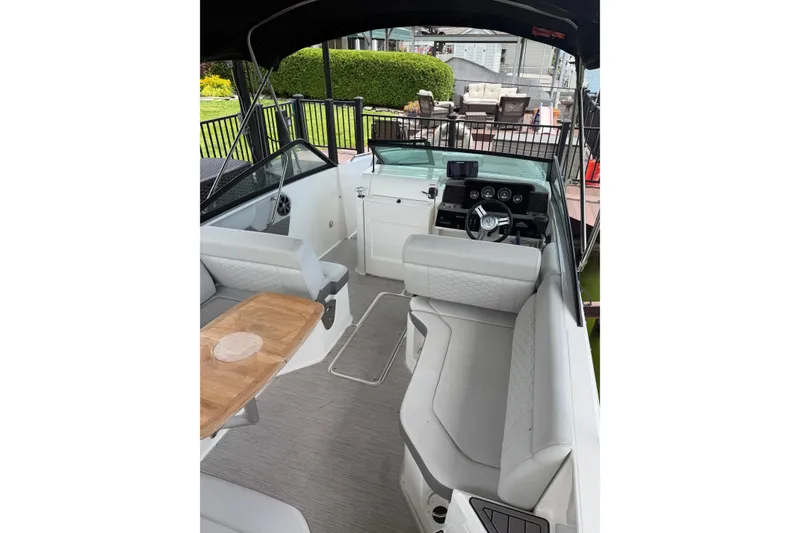 Slide: The Image of Interior of 2021 Sea Ray SDX 250 boat with seating and steering console. - 26