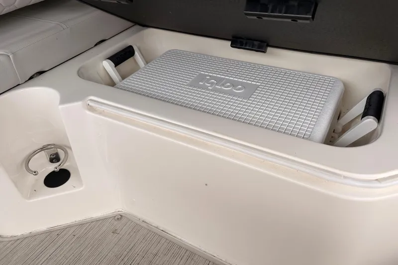 Slide: The Image of Storage compartment with Igloo cooler on a 2021 Sea Ray SDX 250 boat. - 16