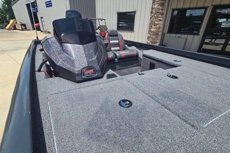 Slide: The Image of 2023 Ranger RT178 boat with spacious deck and sleek design, parked outside a building. - 16