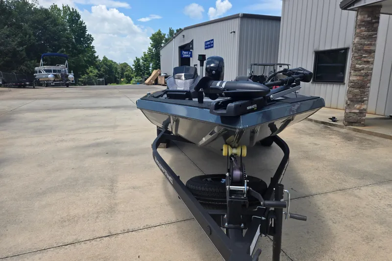 Slide: The Image of 2023 Ranger RT178 boat on trailer outside a building under a blue sky. - 3