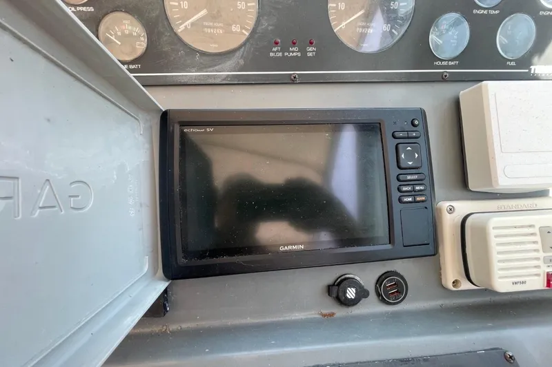 Slide: The Image of Garmin navigation system on 1997 Tiara Yachts 3100 Open dashboard with gauges and controls. - 10