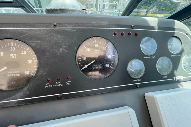 Slide: The Image of Dashboard of a 1997 Tiara Yachts 3100 Open, featuring gauges and indicators. - 12
