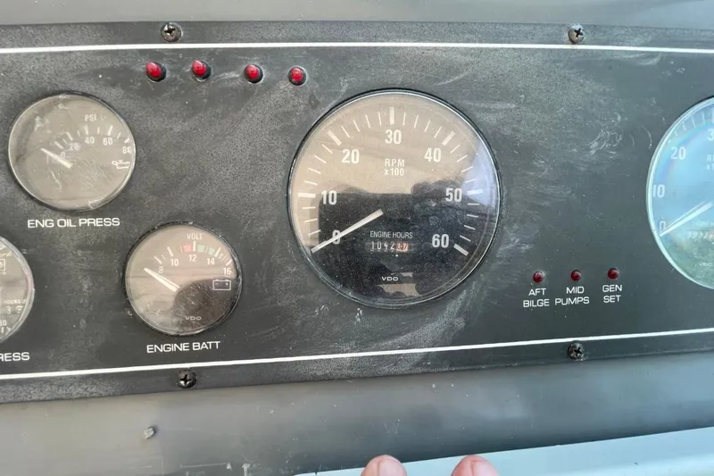 Slide: The Image of Dashboard of a 1997 Tiara Yachts 3100 Open, showing engine gauges and indicators. - 13