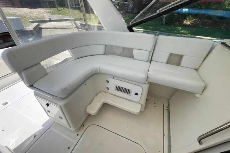 Slide: The Image of 1997 Tiara Yachts 3100 Open interior seating area with white cushioned seats. - 17