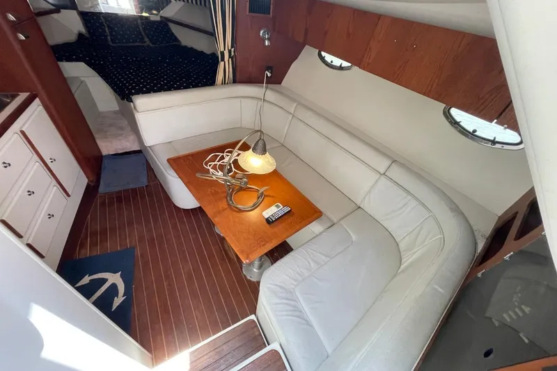 Slide: The Image of Interior of 1997 Tiara Yachts 3100 Open with cozy seating and wooden table. - 18