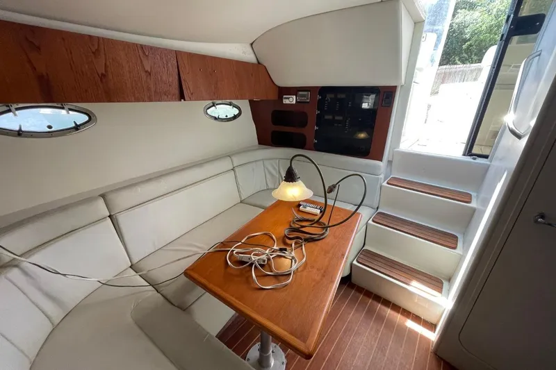 Slide: The Image of Interior of 1997 Tiara Yachts 3100 Open with seating, table, and stairs. - 20