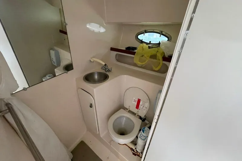 Slide: The Image of Bathroom interior of 1997 Tiara Yachts 3100 Open, featuring sink and toilet. - 22
