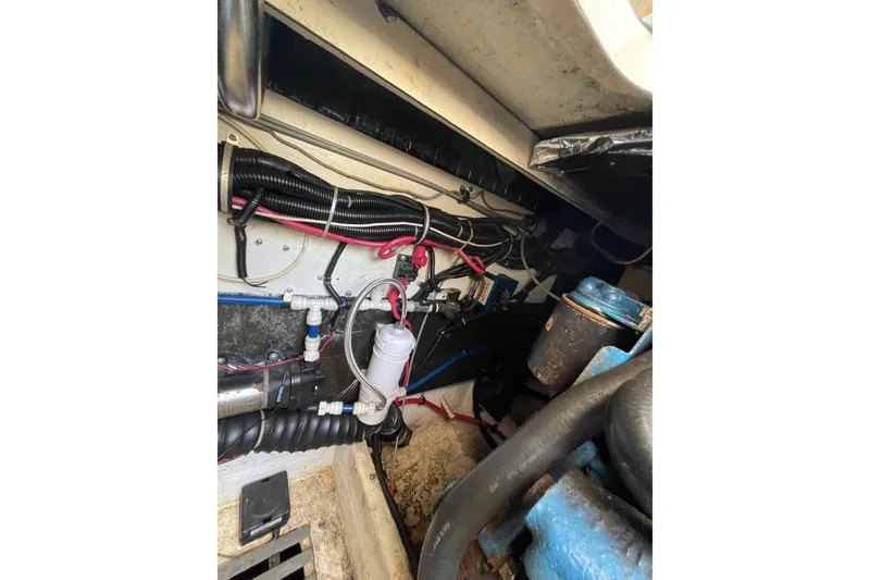 Slide: The Image of Engine compartment of a 1997 Tiara Yachts 3100 Open, showcasing wiring and components. - 28