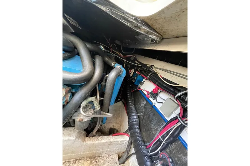 Slide: The Image of Engine compartment of a 1997 Tiara Yachts 3100 Open, showing hoses and wiring. - 29